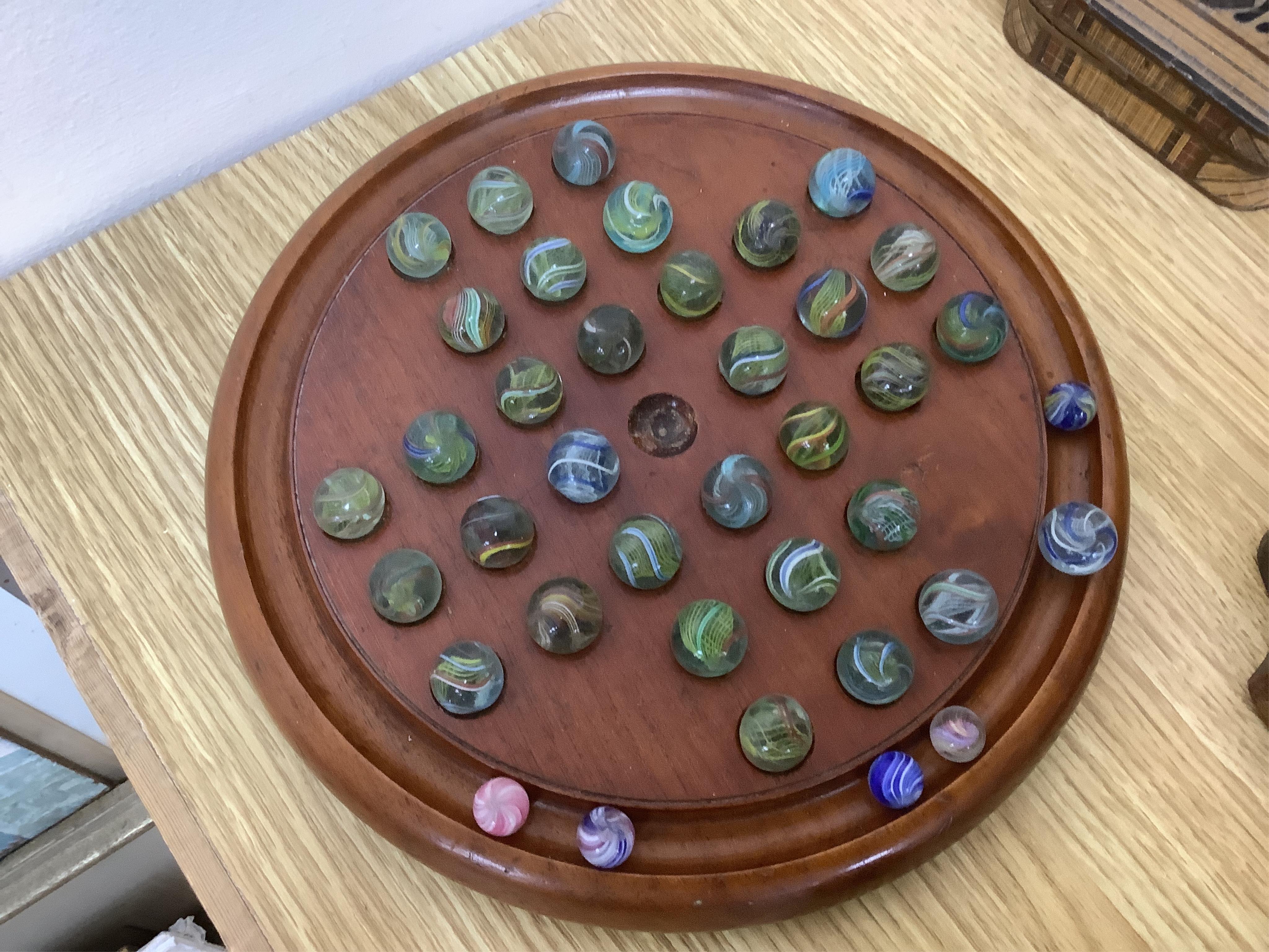 A group of wood items to include two cribbage boards, a mahogany solitaire board with marbles, a truncheon and an inlaid oval tray. etc., largest 60cm wide. Condition - varies, poor to fair